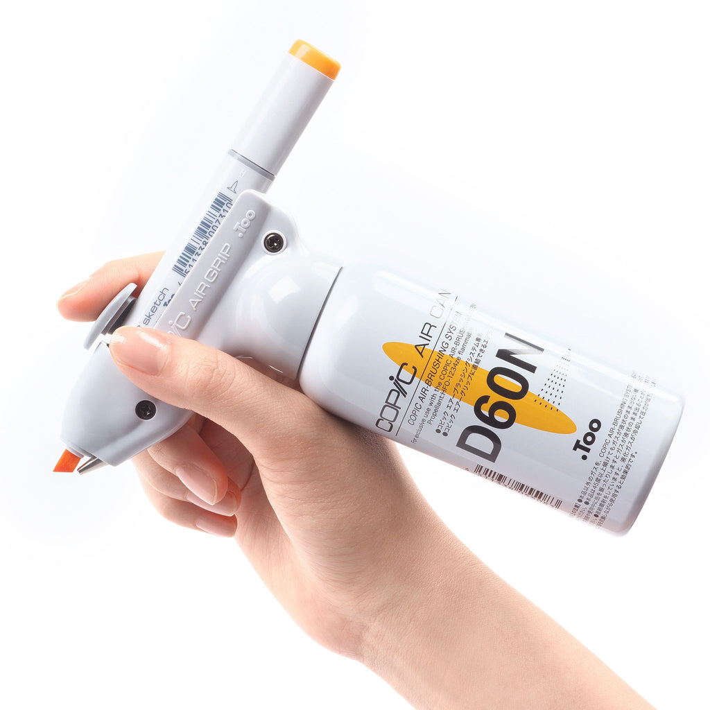 Hand holding AirBrush System with sketch marker, Air Grip, and Air Can D60N.